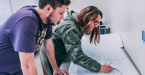 Design+Build Collaborative Team Working over Blueprints