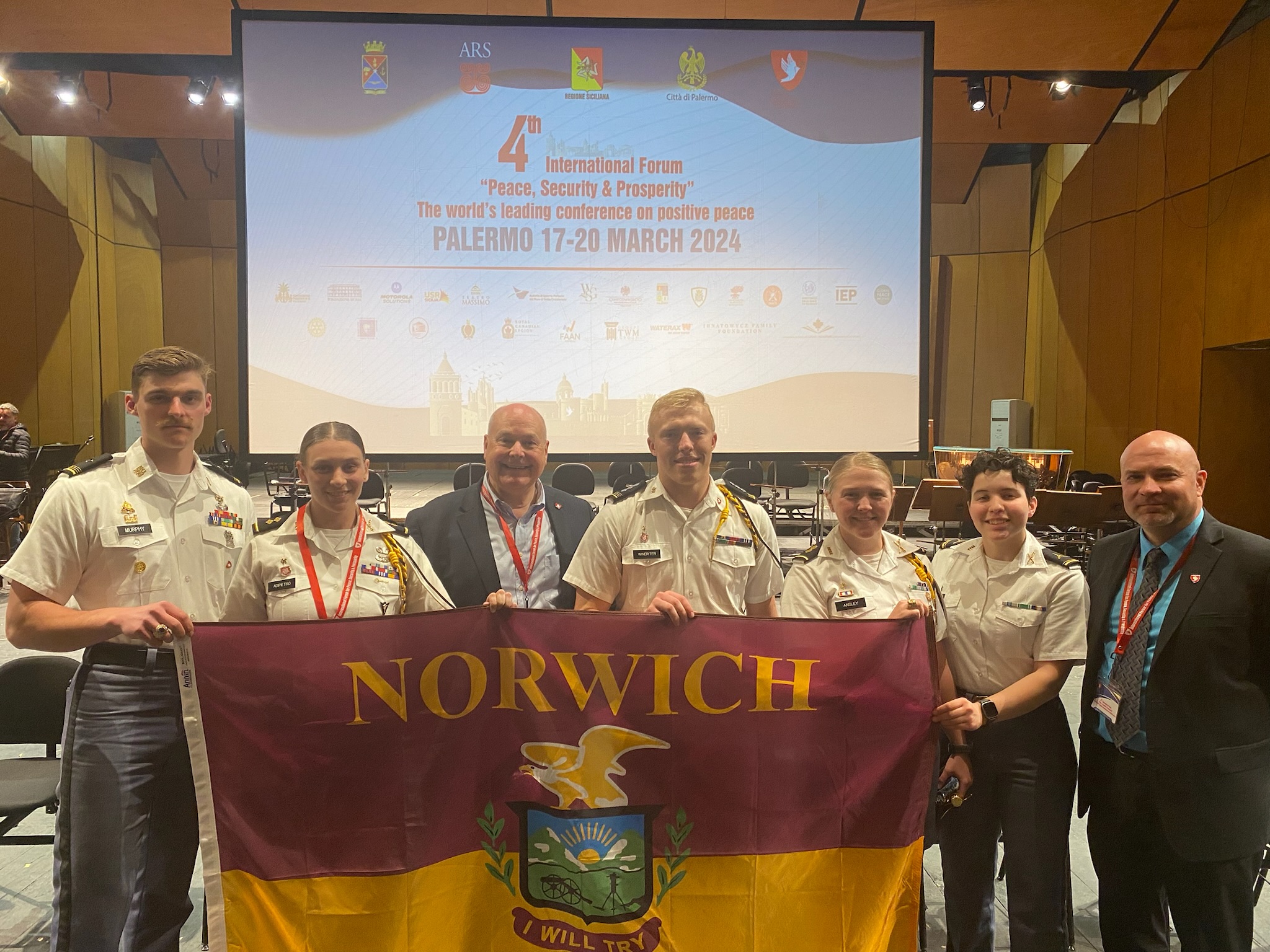 Norwich Cadets and Doctor Morris take picture with the director of the IFPSP, Steve Gregory. 