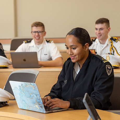Norwich Student in class typing on laptop