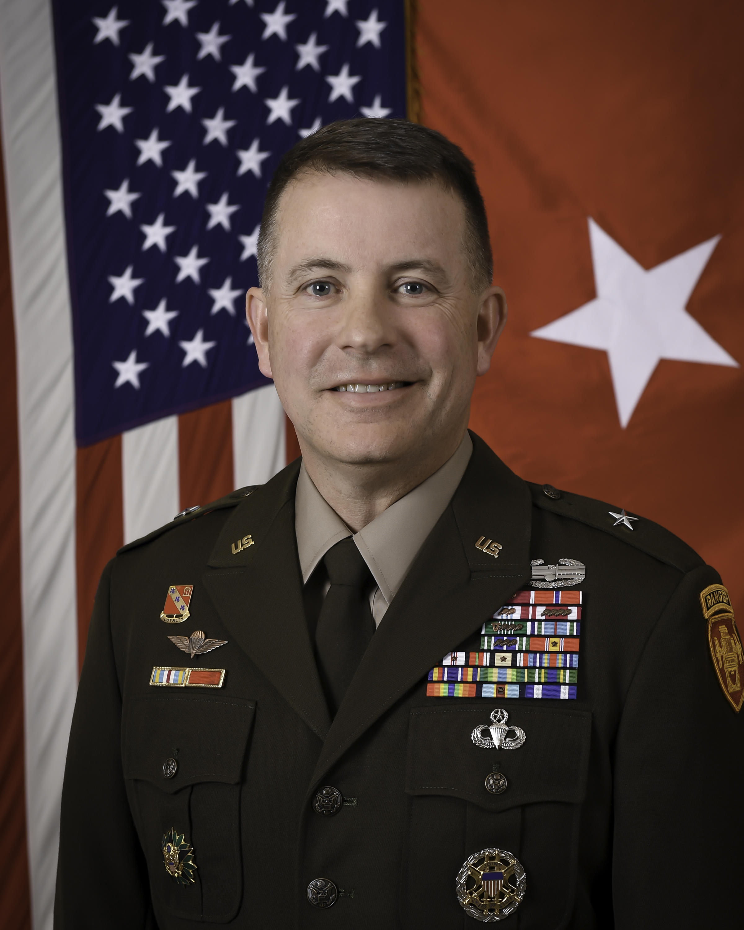Professional photo of United States Army Brigadier General Shane P. Morgan in uniform standing in front of a United States flag.