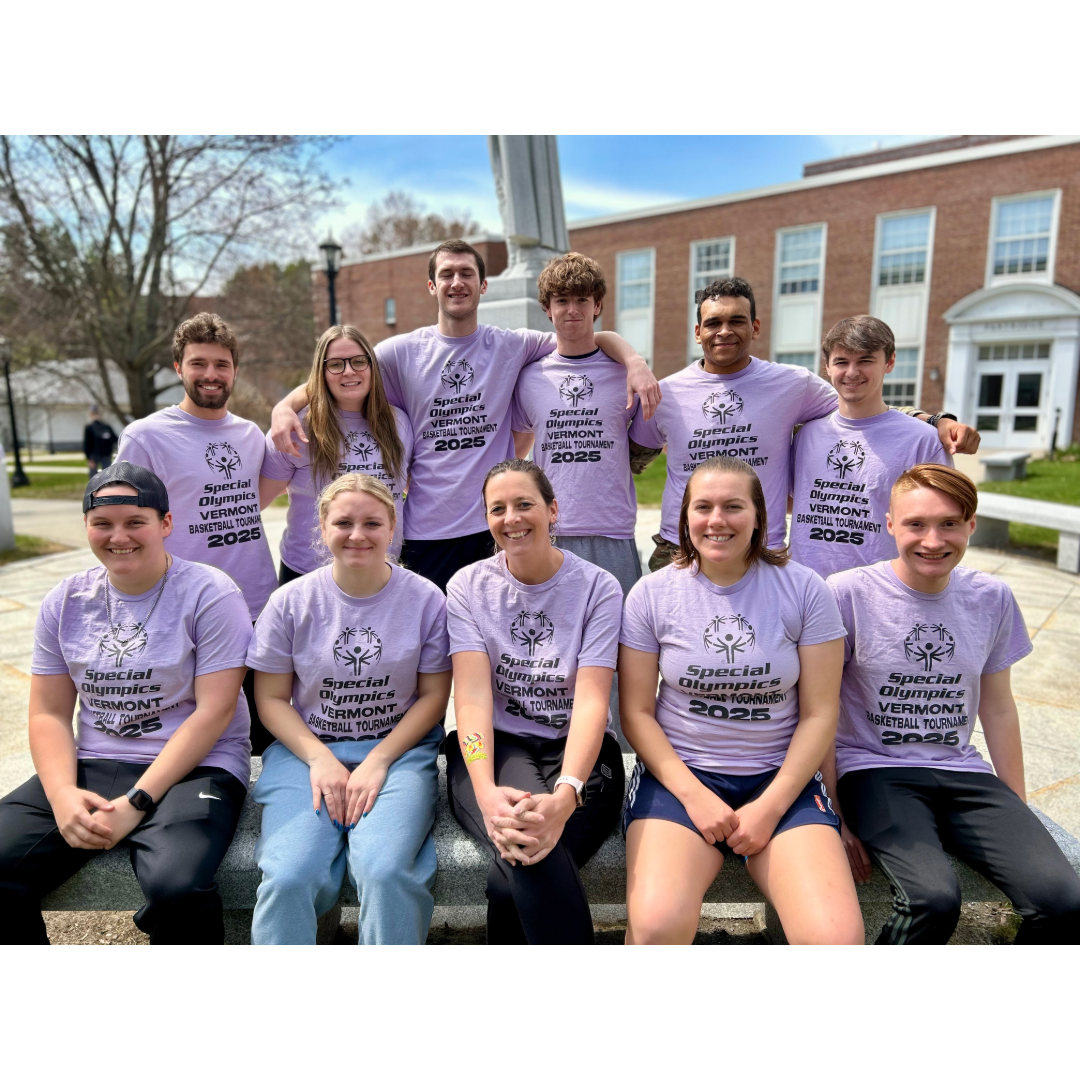 Group of students wearing matching purple t-shirts with Special Olympics Vermont 2025 logos, posing outdoors in front of a building with columns.