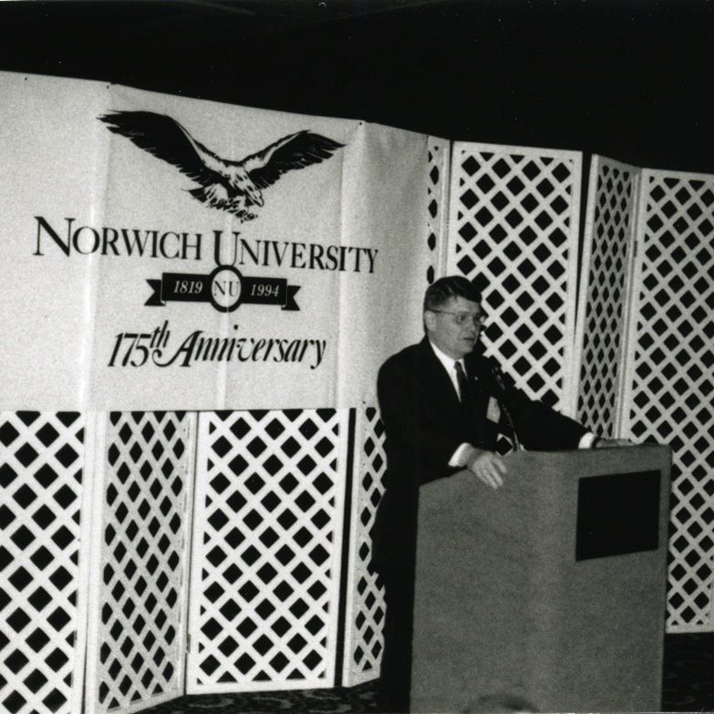 A black and white shot of a man at a podium during the Norwich University 175th Anniversary.