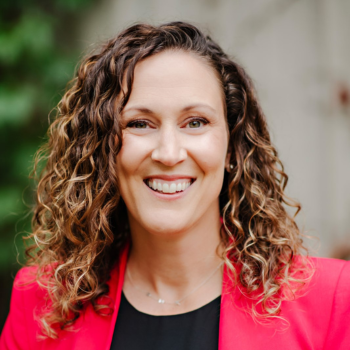 A woman smiles in a professional portrait headshot.