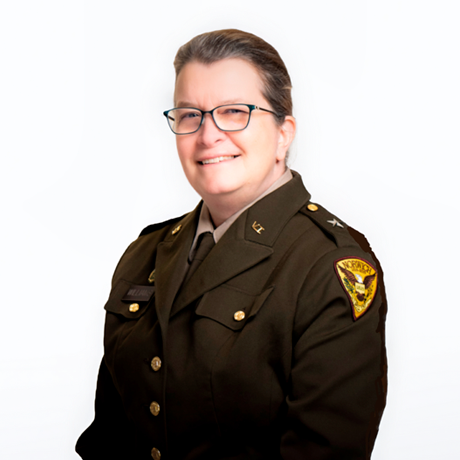 A woman in Vermont State Militia uniform smiles in official portrait photo.