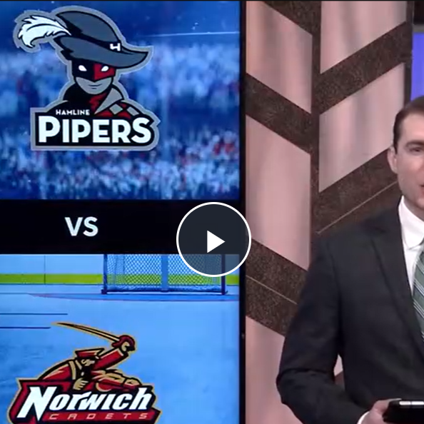 TV anchor stands beside a screen showing Hamline Pipers vs Norwich Cadets hockey matchup.