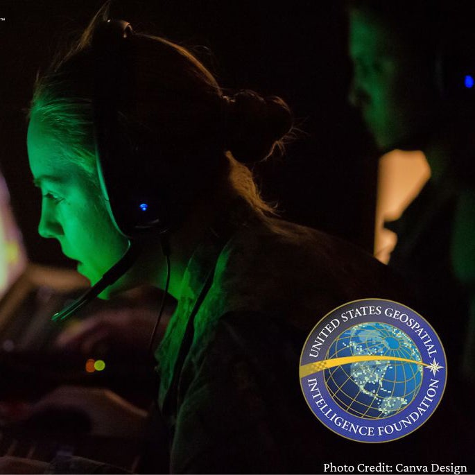 Person wearing a headset uses a computer in a dim room with the Norwich University Go Beyond and USGIF logos visible.