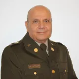 man with head shaved in uniform