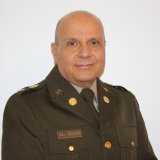 man with head shaved in uniform