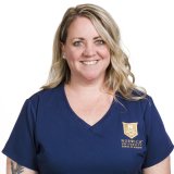 Woman with shoulder-length blond hair in Norwich nursing scrubs