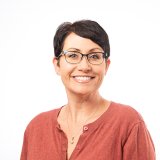 Heather Porter in red sweater, short cropped hair, glasses