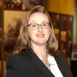 Stephanie Skenyon in black suitcoat with glasses