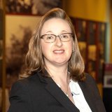Stephanie Skenyon in black suitcoat with glasses