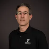 James Bernard with black norwich shirt and glasses