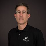 James Bernard with black norwich shirt and glasses