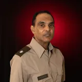 dark haired man in uniform