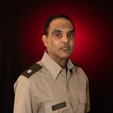 dark haired man in uniform