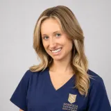 Person wearing navy Norwich University School of Nursing scrubs.