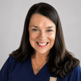 Person wearing navy Norwich University School of Nursing scrubs.