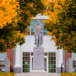 Capt. Alden Partridge statue surrounded by golden fall foliage.