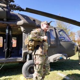 BG Adam Cobb steps off of a Black Hawk Helicopter.