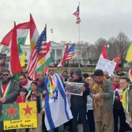 Kurdish Americans and supporters demonstrate outside the White House, carrying Kurdish, U.S., and Israeli flags.