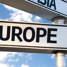 Street sign that says "Europe" with an arrow pointing to the right.