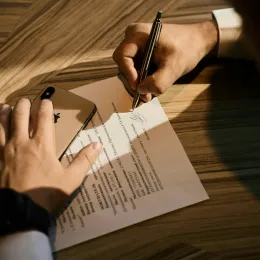 Hands signing document
