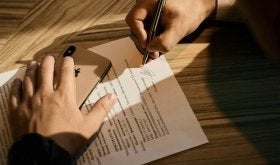 Hands signing document