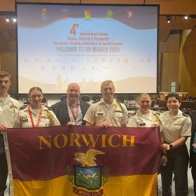 Norwich Cadets and Doctor Morris take picture with the director of the IFPSP, Steve Gregory. 