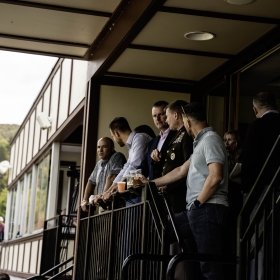 A group of military, Norwich, and NATO officials enjoy a football game from the President's Box.