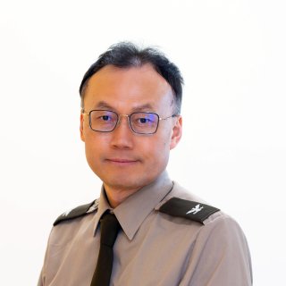 Yangmo Ku in uniform wearing glasses