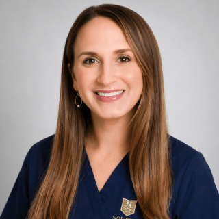 Person wearing navy Norwich University School of Nursing scrubs.