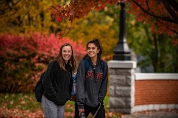 Norwich University civilian students with fall foliage.