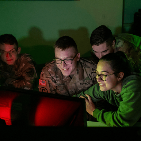 Students working together around a computer in the warroom.