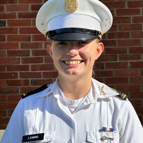 A woman smiles in her white uniform in a standard portrait shot.