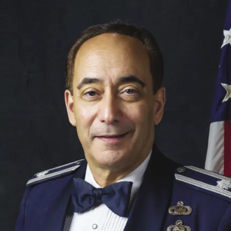 Portrait of Vincent “Vin” Perrone in formal military attire with medals, in front of an American flag.