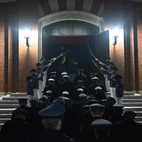 Rooks walk into a building under an archway of drawn swords.