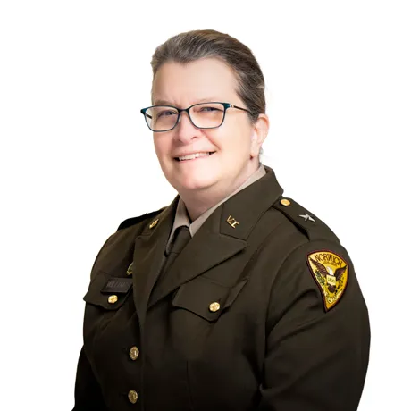A woman in Vermont State Militia uniform smiles in official portrait photo.