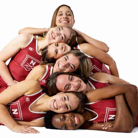 A group of women's wrestlers lie together for a posed shot.