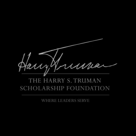 White script and text reading “Harry S. Truman The Harry S. Truman Scholarship Foundation Where Leaders Serve” on a black background.