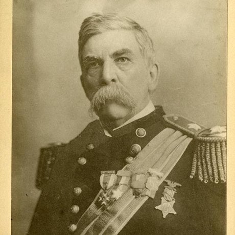 A service member in a decorated military uniform poses for a historical portrait.