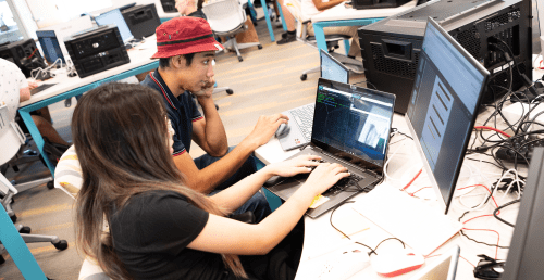 High school students are working together on the computer.