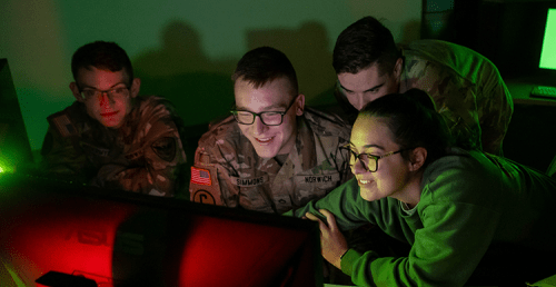 Students working together around a computer in the warroom.