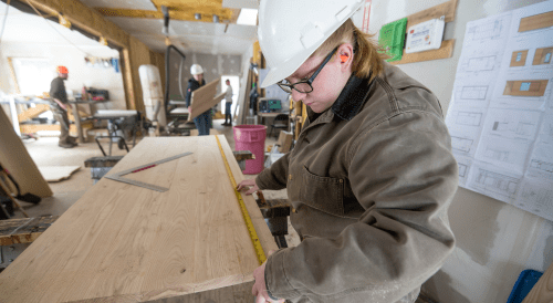 Norwich student working on tiny house construction project.