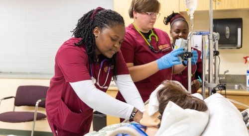 Norwich Nursing majors caring for a simulation patient in our state-of-the-art facility.