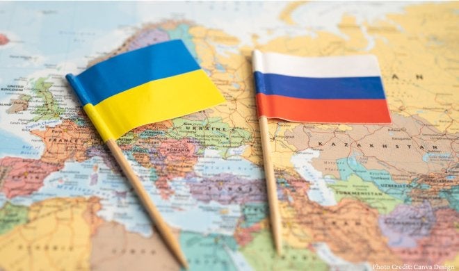 Russian and Ukrainian flag over map of Europe.