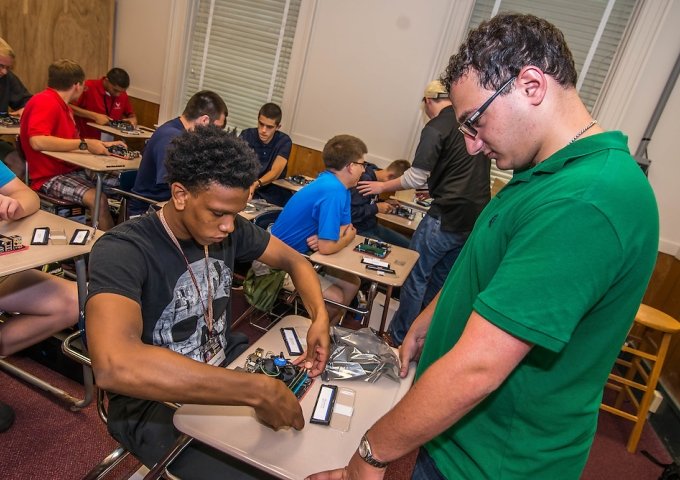 Cyber Immersion Student and Faculty working on tech