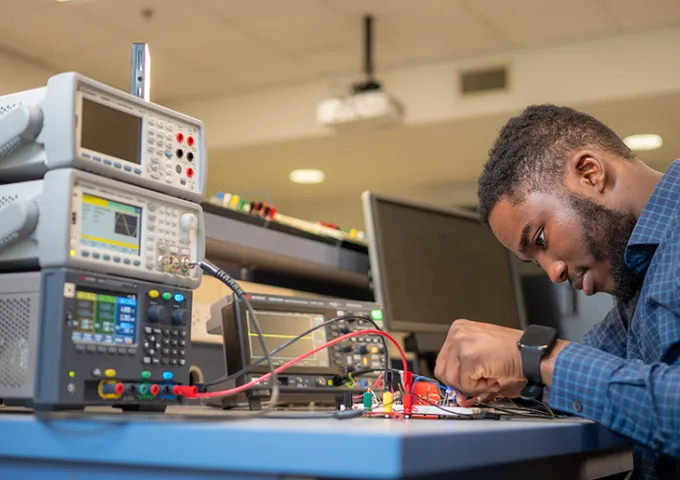 Student studying science equipment.