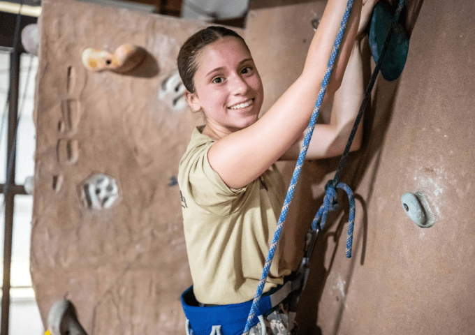 student on rock climbing wall