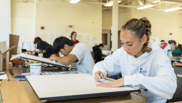 Architecture student works on her design inside Norwich's studio located in Chaplin Hall.